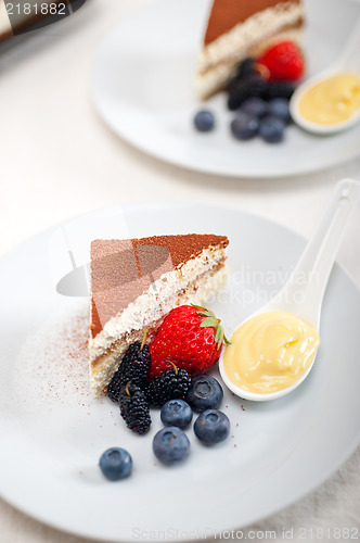 Image of tiramisu dessert with berries and cream