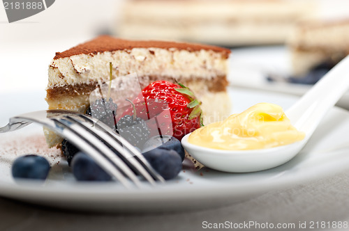 Image of tiramisu dessert with berries and cream