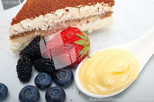 Image of tiramisu dessert with berries and cream