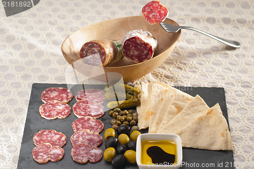 Image of cold cut platter with pita bread and pickles