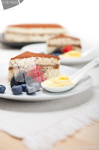 Image of tiramisu dessert with berries and cream