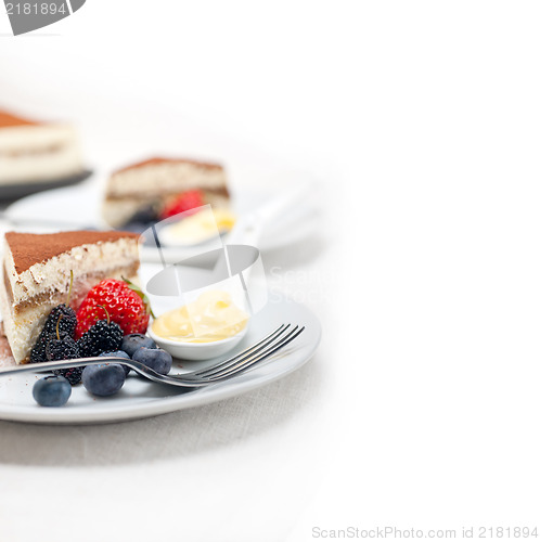 Image of tiramisu dessert with berries and cream