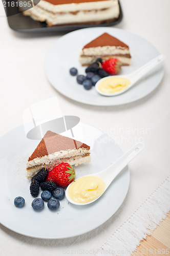 Image of tiramisu dessert with berries and cream