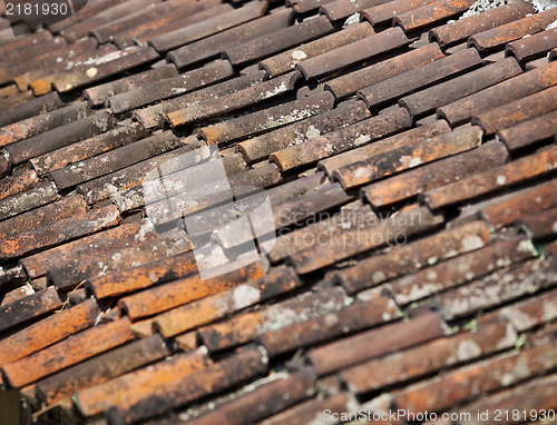 Image of Old red weathered clay tiled roof surface