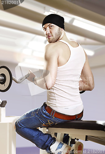 Image of man in gym with bar