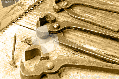 Image of old rusty pliers with nail