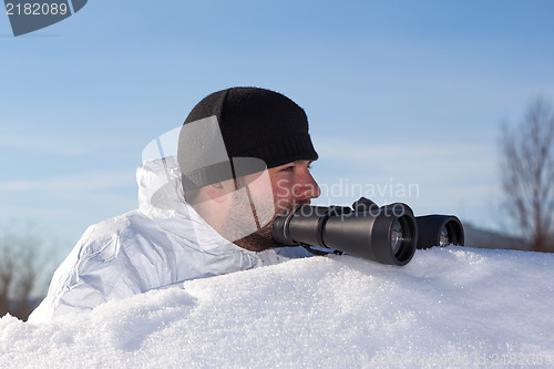 Image of Scout in white camouflage coat with binoculars