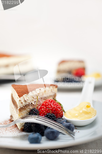 Image of tiramisu dessert with berries and cream