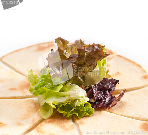 Image of garlic pita bread pizza with salad on top