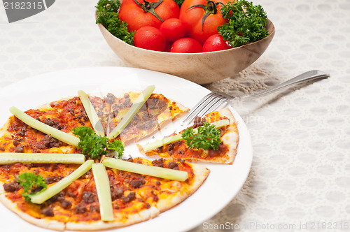 Image of Turkish beef pizza with cucumber on top