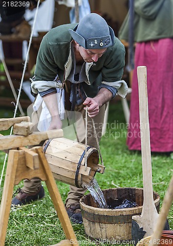 Image of Medieval Man Pouring Water