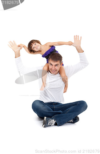 Image of Cheerful daughter on the neck with his father in the studio