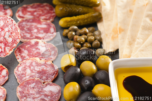 Image of cold cut platter with pita bread and pickles