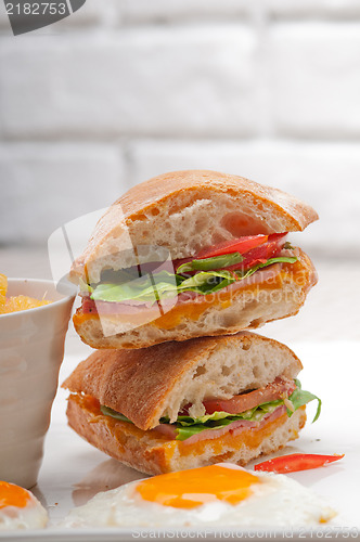 Image of ciabatta panini sandwich eggs tomato lettuce