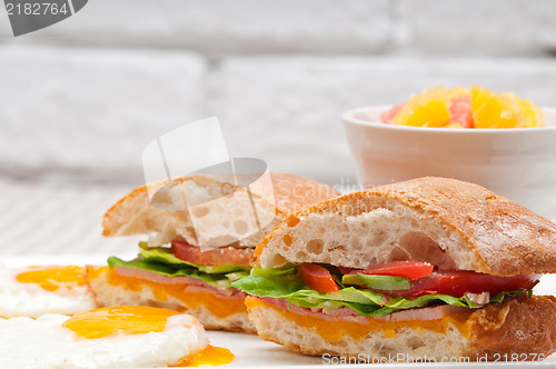 Image of ciabatta panini sandwich eggs tomato lettuce