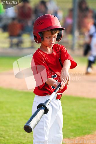 Image of Boy warming up to bat