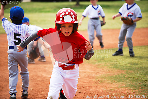 Image of Little league baseball player running bases