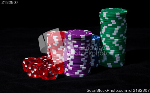 Image of Stacks of Poker Chips with Playing Bones