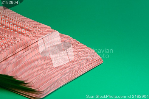 Image of Deck of poker cards on green table