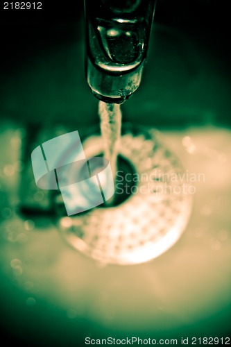 Image of Water dripping from water tap , artistic retro style toned photo