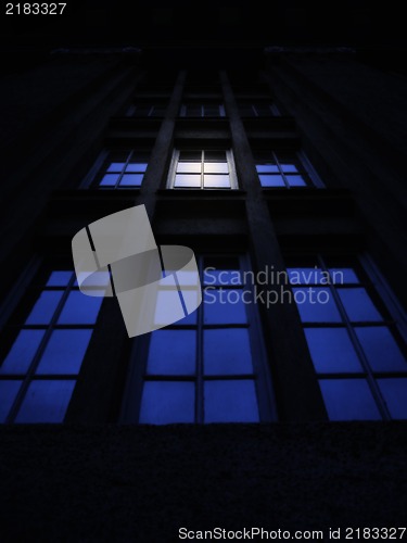 Image of Working late concept , illuminated window in the night
