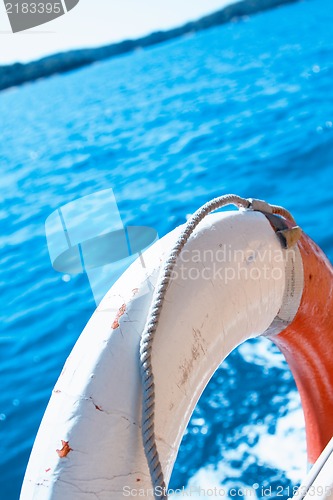Image of White life buoy on the boat fence