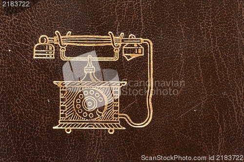Image of Old leather telephone book with golden telephone symbol