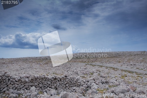 Image of Beautiful rocky hill with aged stone wall ruins