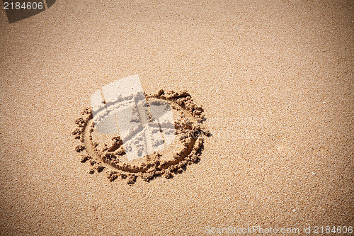 Image of Peace symbol on the sand beach
