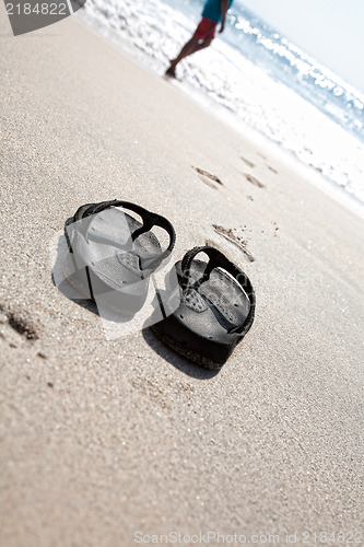 Image of Flip flops on a sand beach