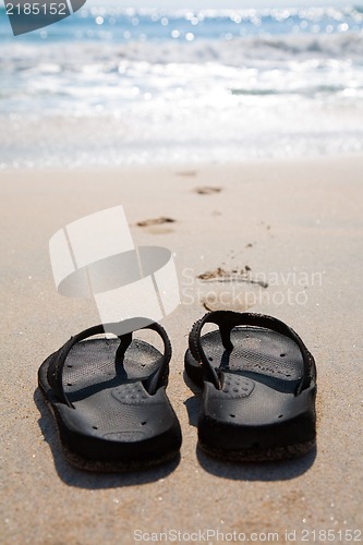 Image of Flip flops on a sand beach