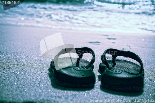 Image of Flip flops on a sand beach