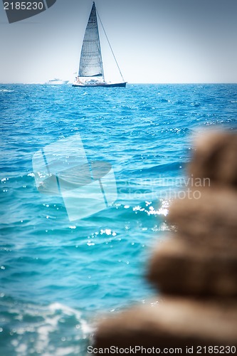 Image of Sailboat near the coast on a sunny day