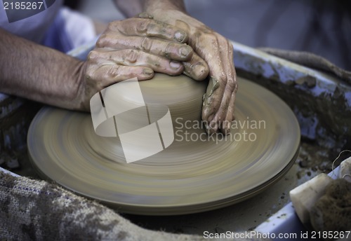 Image of Hands working on pottery wheel