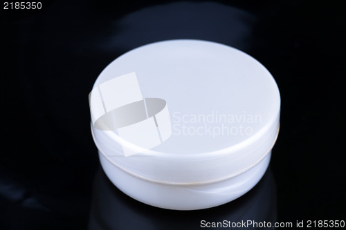 Image of Box of cream on black background