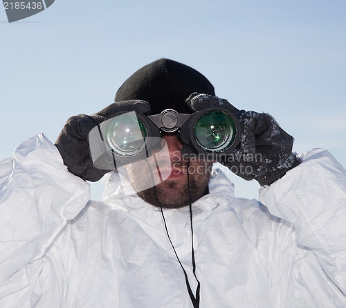 Image of Special Forces soldier in white camouflage looking through binoc