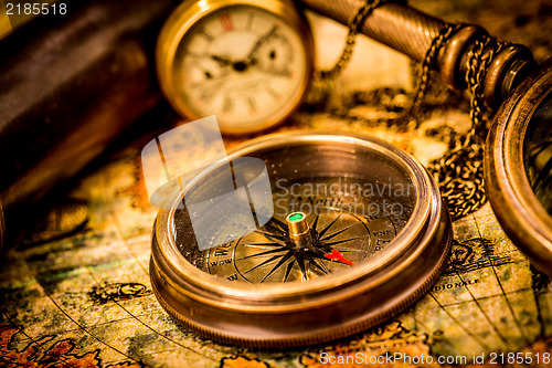 Image of Vintage compass lies on an ancient world map.