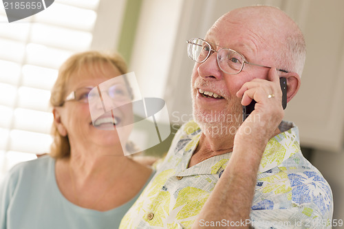 Image of Senior Adult Husband on Cell Phone with Wife Behind