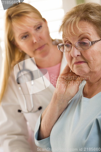 Image of Senior Adult Woman Being Consoled by Female Doctor or Nurse