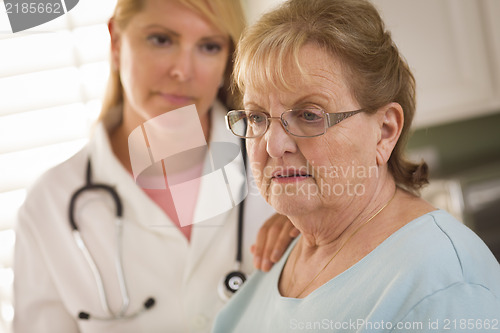 Image of Senior Adult Woman Being Consoled by Female Doctor or Nurse