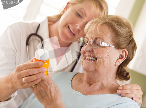 Image of Female Doctor or Nurse Explaining Prescription to Senior Adult W