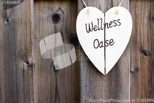 Image of Wooden fence and wellness signboard