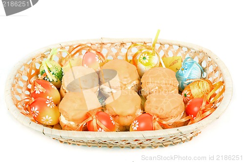 Image of easter eggs and homemade sweet cakes in basket