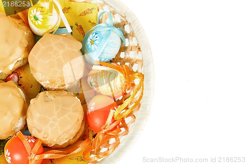 Image of easter eggs and homemade sweet cakes in basket