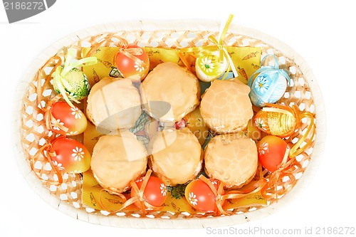 Image of easter eggs and homemade sweet cakes in basket