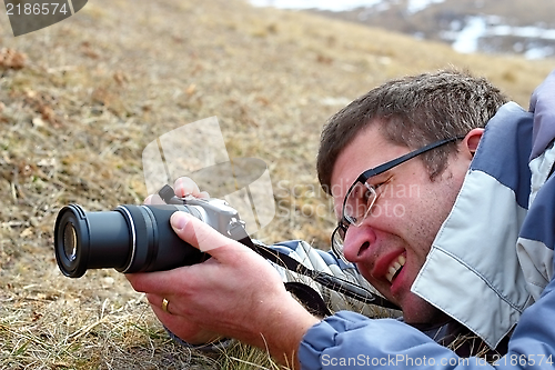 Image of man taking pictures in the field