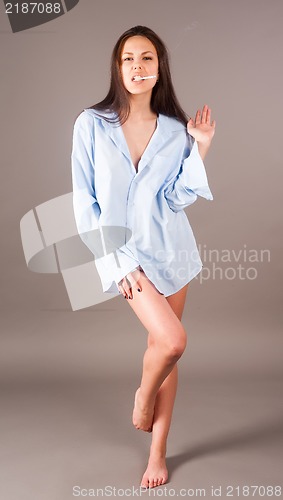 Image of beautiful young brunette woman with cigarette