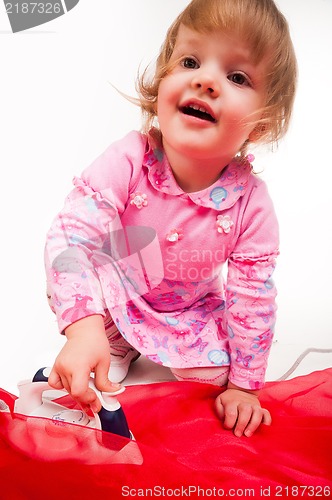 Image of little, blond hair girl ironing