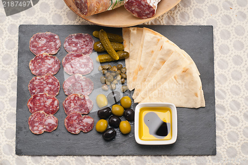 Image of cold cut platter with pita bread and pickles