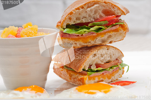 Image of ciabatta panini sandwich eggs tomato lettuce